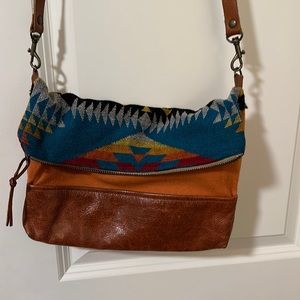 Cross body unique wool and leather blend. nan-made is the designed